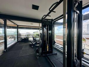 a gym with treadmills and benches in a building at Restinga 305- Flat vista mar no Bessa - ASKA in João Pessoa