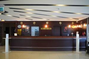 a hotel lobby with a reception counter and clocks at Burgaz Resort Aquapark Hotel in Kırklareli +13 photos