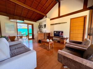 a living room with two couches and a table at Chalet Monte Boa Vista - Aconchego na Serra com Hidromassagem Exclusiva in Teresópolis
