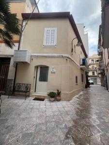a building with a window on the side of it at Kyma Apartment - Giardini Naxos in Giardini Naxos
