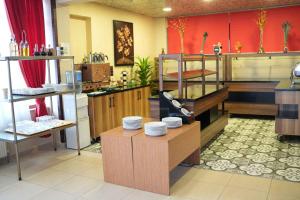 a kitchen with a table with plates on it at Burgaz Resort Aquapark Hotel in Kırklareli