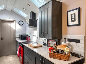 a kitchen with a counter with a basket on it at Jasmine Cottage in Grassington +21 photos