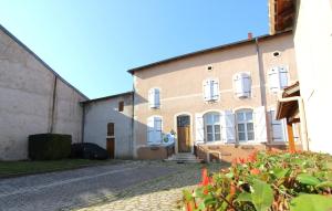 a large brick building with a door on a street at Chambre n4 Maison dHôtes de Charme in Maizières