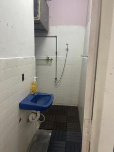 a bathroom with a blue sink and a shower at Sejiwo Apartment 6-8pax in Pengkalan Cepa +5 photos