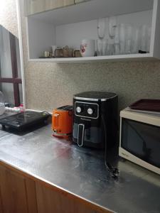 a kitchen counter with a microwave and a toaster at Guest House Urdoviza in Kiten