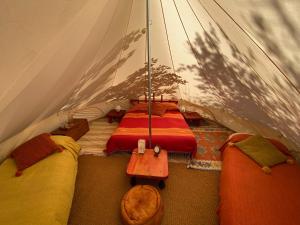 a tent with two beds and a table in it at Podere di Maggio - Glamping tent 3 in Santa Fiora