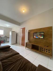 a living room with a tv on the wall at Ed The Rock in Belém