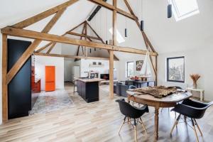 a kitchen and living room with a table and chairs at Large bright apartment in Lessines