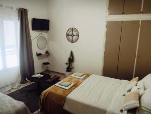 a bedroom with a bed and a clock on the wall at Mia Nest in Artemida
