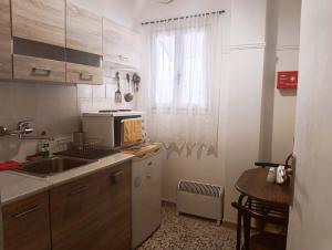 a small kitchen with a sink and a window at Mia Nest in Artemida