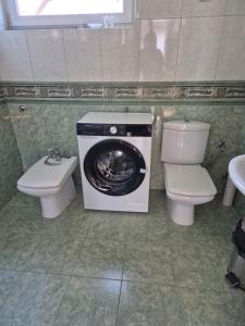 a toilet and a washing machine in a bathroom at Pokoje gościnne Beata (Niska1) in Krynica Morska +23 photos