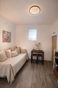 a bedroom with a bed and a table at Eleni`s apartment Gialova, Giorgos House in Gialova