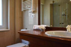 a bathroom with a sink and a toilet and a mirror at Thalore room e apartments in Amantea