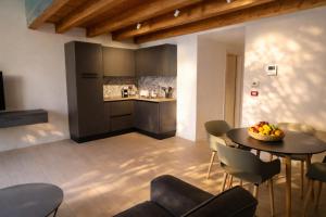 a kitchen and dining room with a table and chairs at Noor Palace - PI Collection Hotel in Palermo