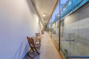 a hallway with chairs and a table in a building at HI Ponte de Lima - Pousada de Juventude in Ponte de Lima