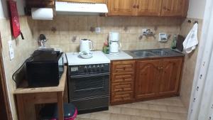 a small kitchen with a stove and a sink at The Rock View in Petra +16 photos