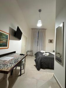 a bedroom with a bed and a table in it at Ostello City In Hostel B&B in Catania