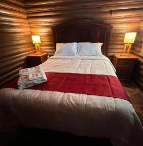 a bedroom with a large bed with two lamps on tables at Hotel La Leyenda Sonora in El Saucito +31 photos