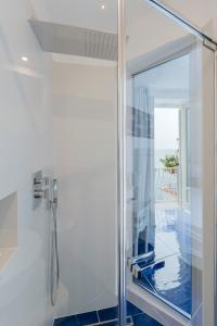 a shower with a glass door in a bathroom at Donna Giulia in Amalfi +119 photos