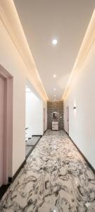 an empty hallway with a carpeted floor in a building at The Meer Mansion in Srinagar