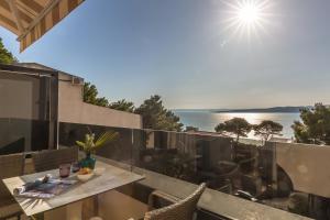 a view of the ocean from the balcony of a house at Villa REANA in Brela