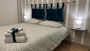 a bedroom with a bed with blue pillows at Casa Verdi in Corleone +11 photos