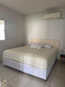 a white bedroom with a large bed in it at rafaela cardoso souza in Água Boa