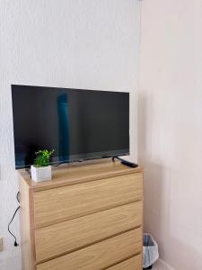 a flat screen tv sitting on top of a wooden dresser at La 10a de Las Charcas in Guatemala +9 photos