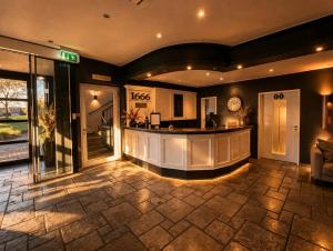a lobby with a bar in a building at Gut Dyckhof in Meerbusch