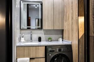 a bathroom with a sink and a washing machine at Auezov City in Almaty +46 photos