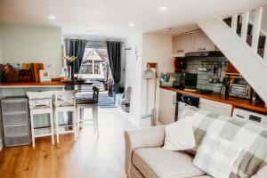 a living room with a couch and a kitchen at Gwens House in Brynsiencyn
