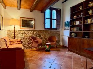 a living room with a couch and a stone wall at Casa Fochita in Gratteri