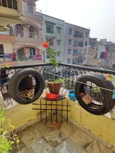 two tires hanging on a railing on a balcony at mahitra beautiful homestay in Patna