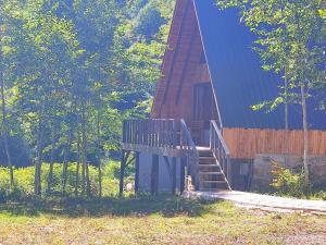 a wooden cabin with a staircase leading to a house at İtenicibungolow in Korgan