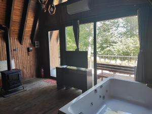 a large bathroom with a tub and a stove at İtenicibungolow in Korgan