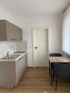 a kitchen with a sink and a table with chairs at Weingut Lehnert-Später in Piesport