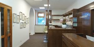 a hospital room with a counter with flowers on the wall at vitalArmonie Retreat in Marzio