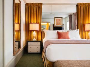 a hotel room with a large bed and a mirror at The Hotel Lili in Los Angeles +78 photos
