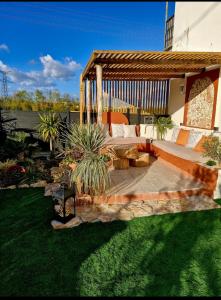 a backyard with a bed and a gazebo at Gîte Les Galins in Lux