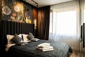 a bedroom with a bed with towels on it at Auezov City in Almaty
