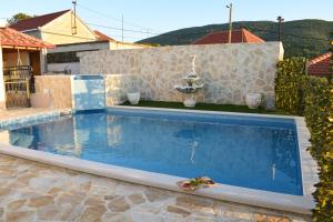 a swimming pool with a toy in a house at Villa Marko in Ljubitovica
