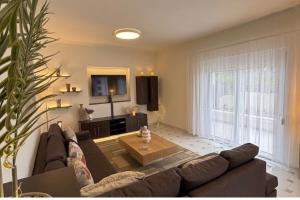 a living room with a couch and a coffee table at Villa Lonaki in Haraki