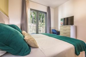 a bedroom with a bed with a television and a window at Villa REANA in Brela