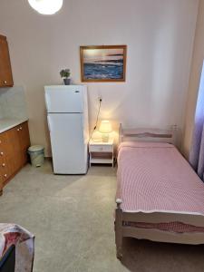 a room with two beds and a refrigerator at ILIANA apartments in Preveza +17 photos