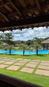 a view of a swimming pool with trees next to it at Estância da Mata in CÃ¡ssia