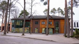 a building with trees in front of it at Valmiera Park Hostel in Valmiera