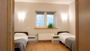 a room with two beds and a window at Valmiera Park Hostel in Valmiera