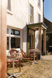 a group of tables and chairs in front of a building at The Wensleydale Hotel in Middleham +74 photos