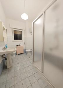 a bathroom with a shower and a sink and a toilet at Appartamento - Ladispoli in Ladispoli