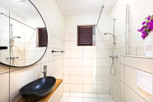 a bathroom with a black sink and a shower at Villa The Hidden Palm, Piscadera, Private Pool in Willemstad +36 photos